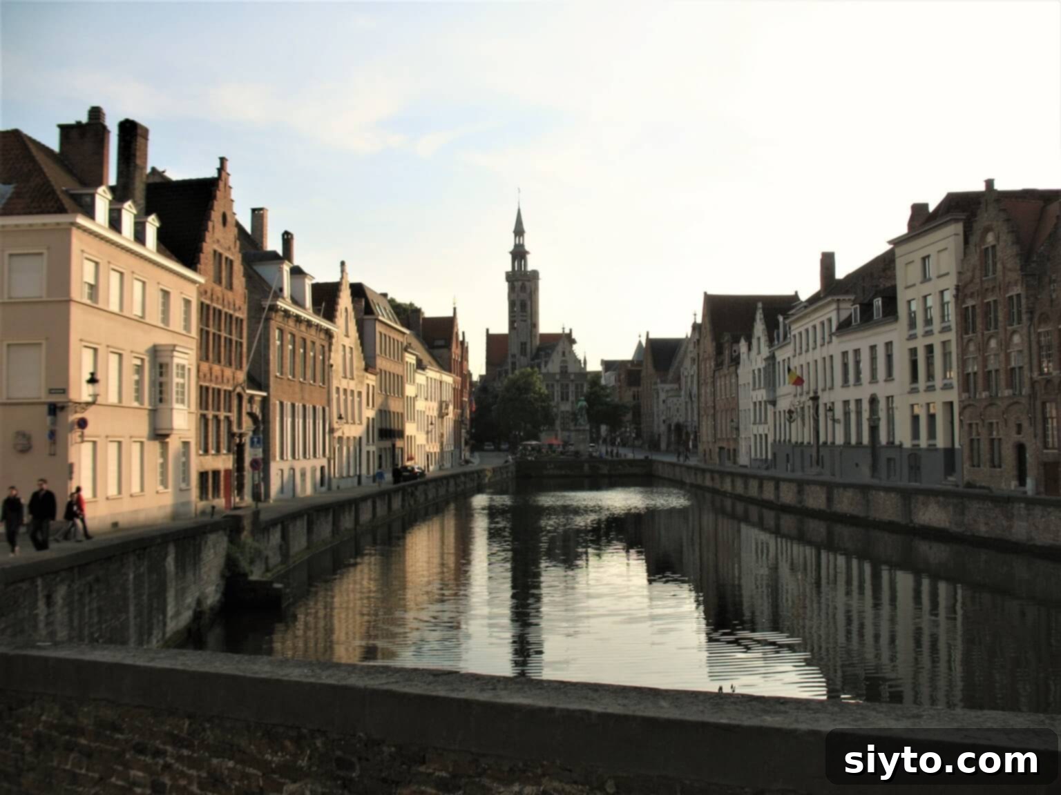 Chicons au Gratin: A Taste of Our Belgian Journey 4 Scenic view looking down a tranquil canal in Bruges, Belgium, lined with historic buildings