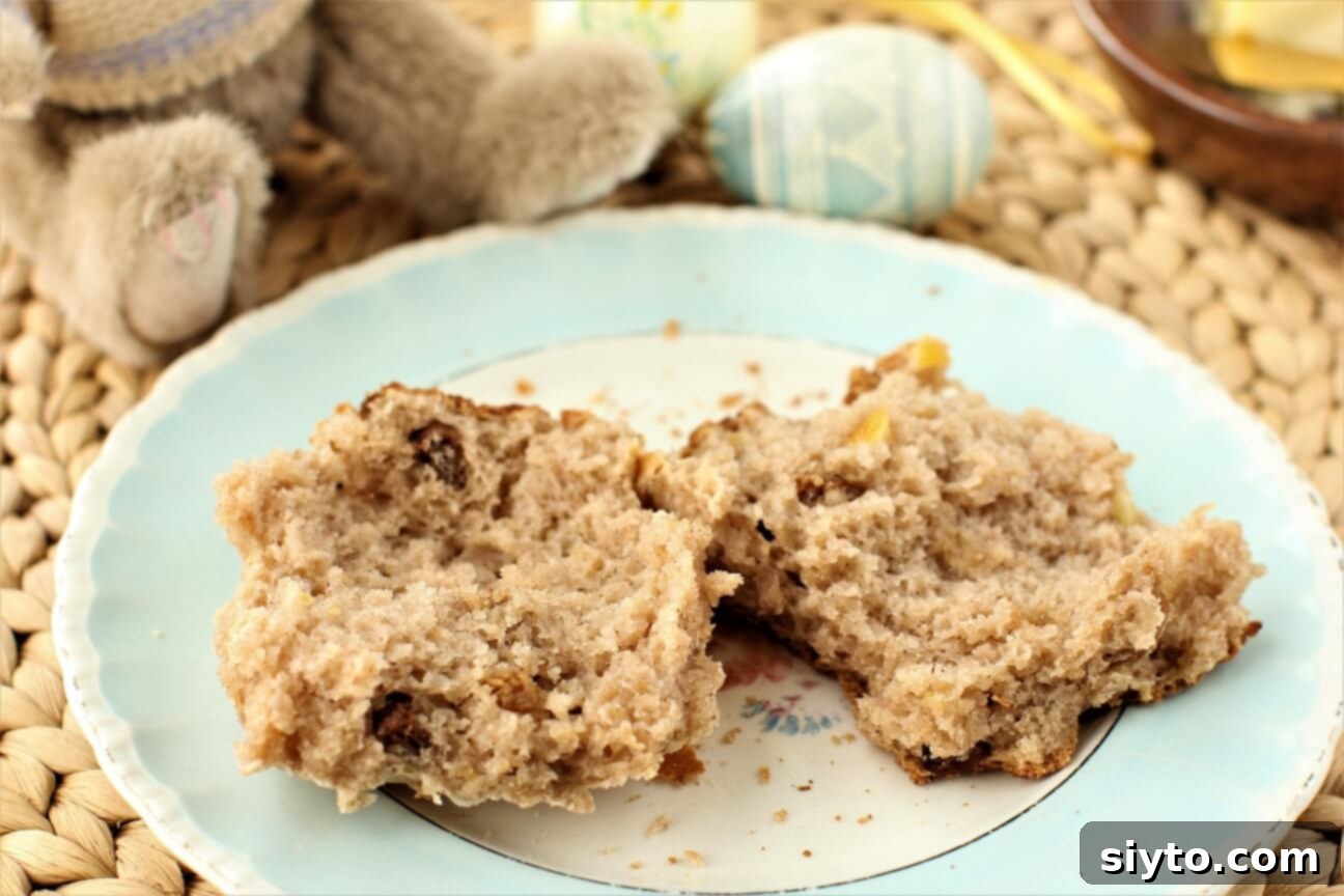 Fluffy Gluten-Free Hot Cross Buns 13 A perfectly split open gluten-free Hot Cross Bun, revealing its soft, springy, raisin-filled interior