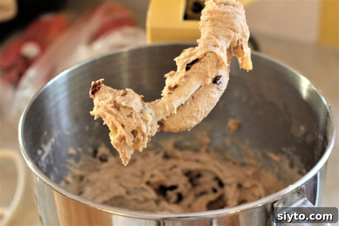 Fluffy Gluten-Free Hot Cross Buns 5 Sticky gluten-free hot cross buns dough mixing in a stand mixer with a dough hook, showing the texture