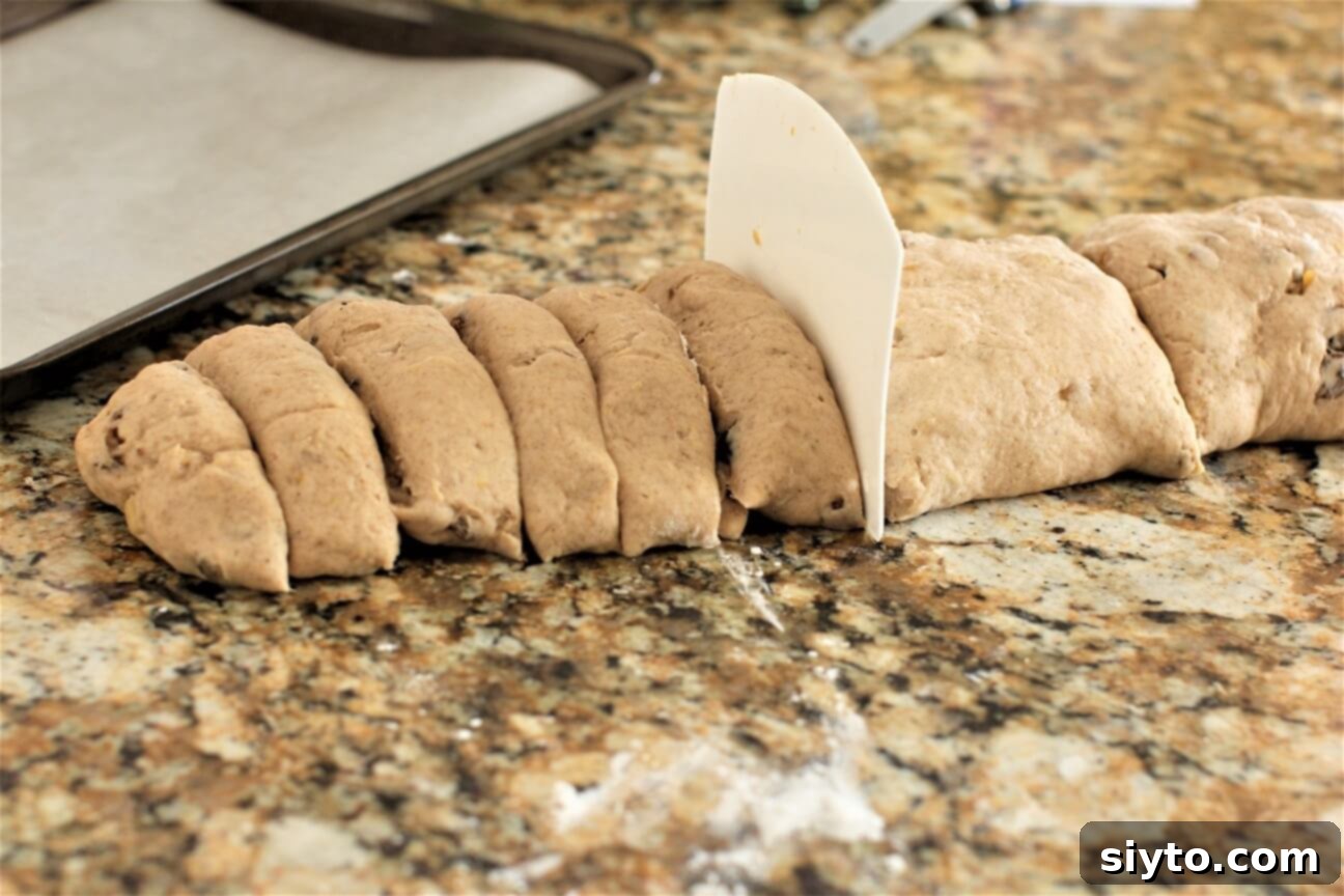 Fluffy Gluten-Free Hot Cross Buns 8 Dividing gluten-free hot cross bun dough into equal sections to prepare for shaping