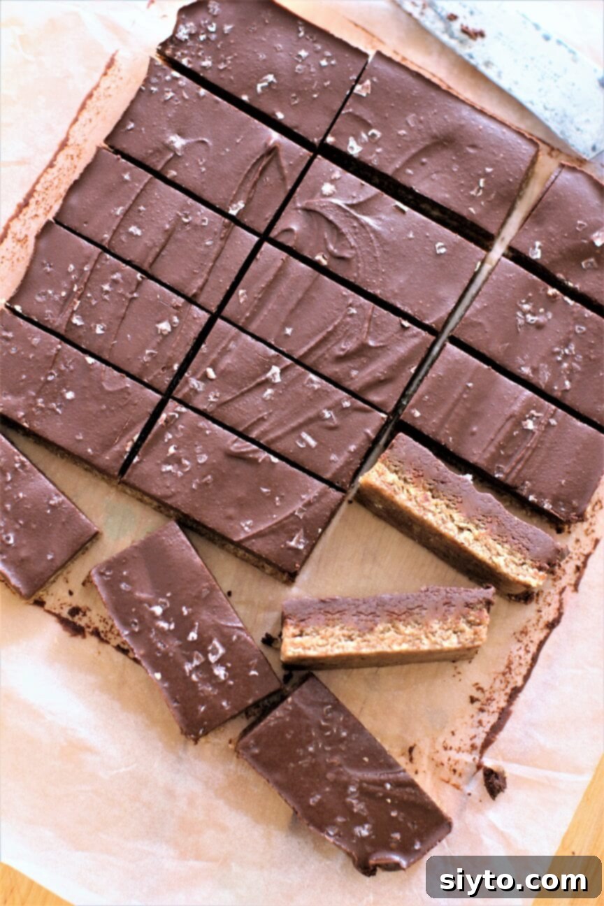 No-Bake Chewy Chocolate Almond Bars neatly sliced on parchment paper, ready to be enjoyed.