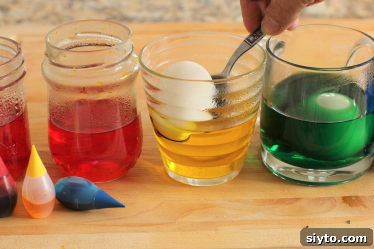 Craft Beautiful Easter Eggs 5 how to dye eggs - dropping the egg into a glass of yellow colour