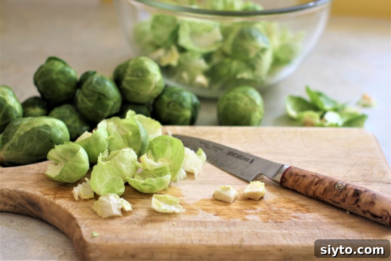 Separating the small Brussels sprouts into individual leaves for the salad preparation