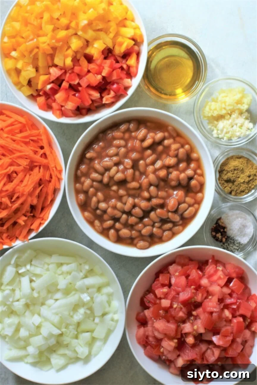 Chakalaka & Pap: Lesotho's Soul Food 5 Individual bowls containing all the fresh ingredients needed for Chakalaka: red and yellow peppers, shredded carrots, baked beans, onions, tomatoes, alongside oil, minced ginger and garlic, curry powder, salt, pepper, and chili flakes.