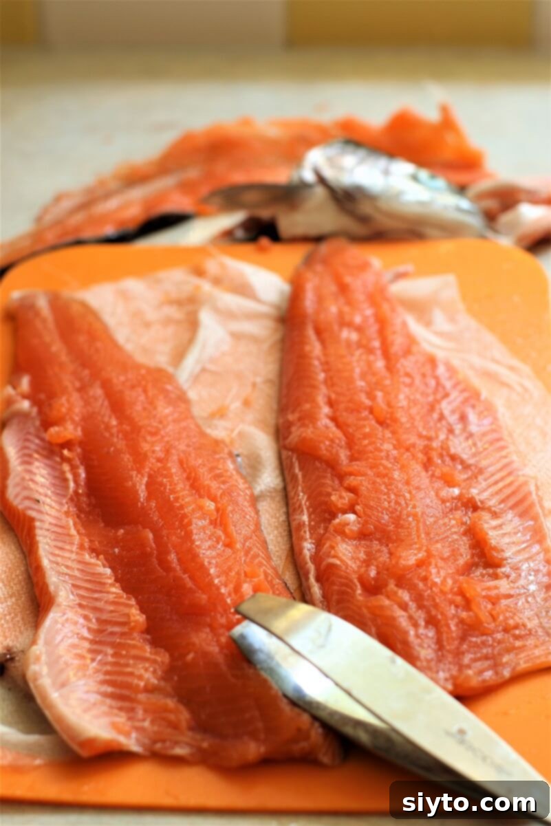 Two beautifully pink, freshly filleted trout, ready for cooking. While not perfect, they represent a proud first attempt at filleting.