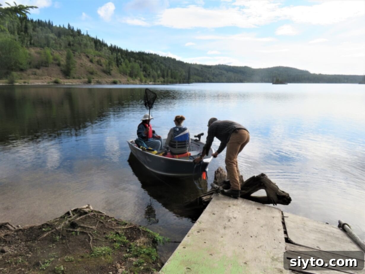 Nancy, Clay, and Jessica pushing off a small boat from the dock, embarking on a fishing adventure on the lake.