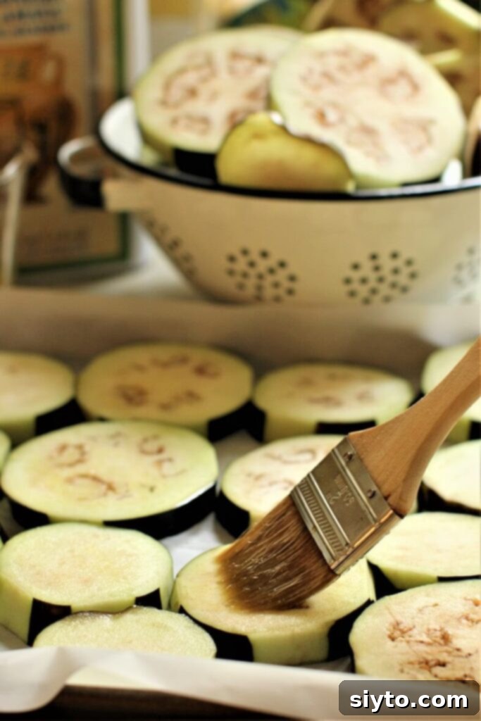 brushing oil on the eggplant slices