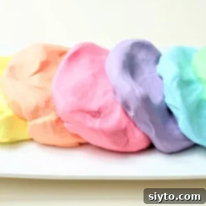 Blobs of beautifully pastel colored cloud dough, soft and inviting for play.