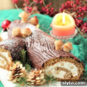 Festively decorated German Yule Log cake with marzipan mushrooms and pine cones, garnished with greenery and a soft candle glow in the background, showcasing a delicious holiday dessert.
