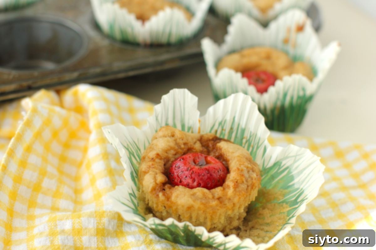 close-up of a baked Peek-a-Boo muffin with the paper pulled away from its sides.