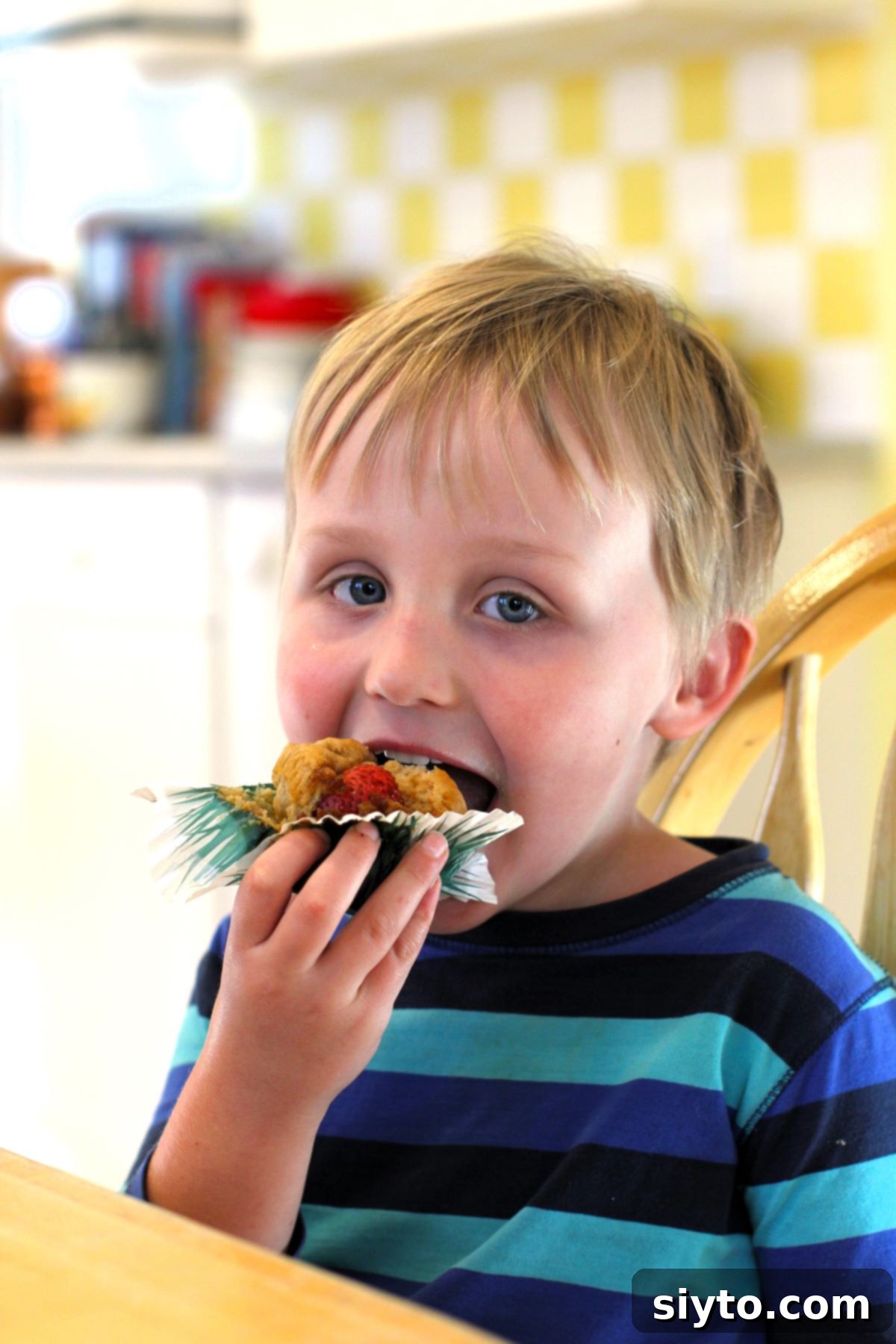 Caleb taking a bite out of his Peek-a-Boo muffin.