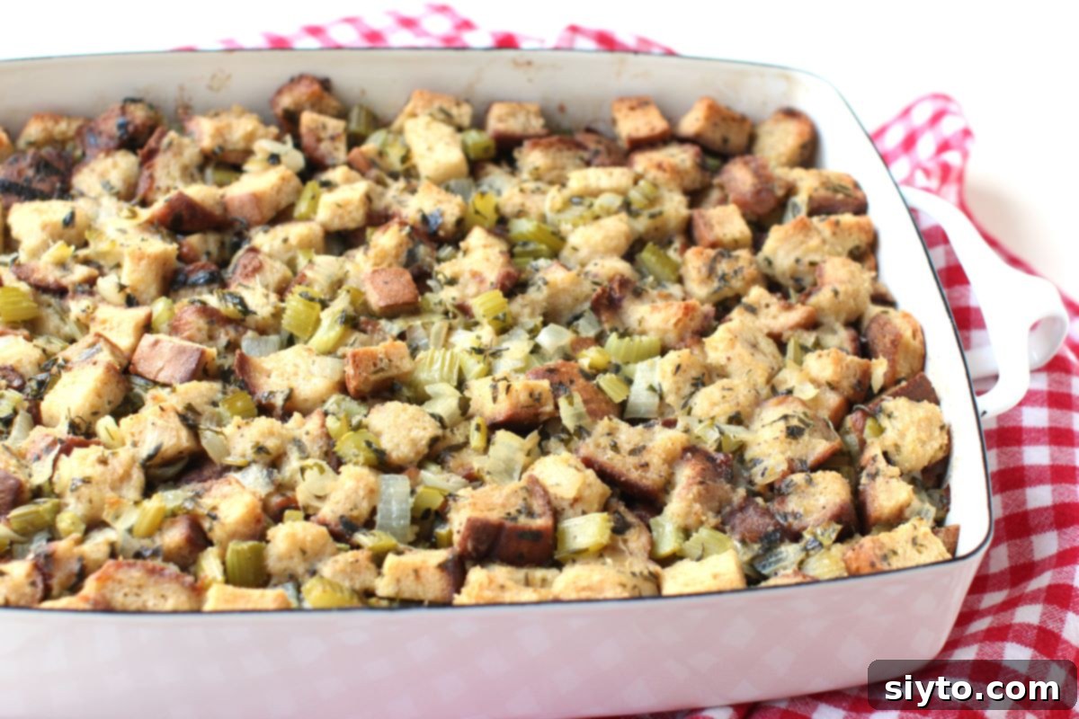 A side view of a golden-brown pan of gluten-free stuffing, showing the depth of the dish and the inviting texture of the stuffing's top layer.