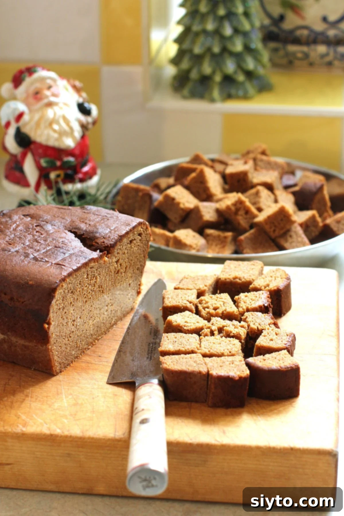 cutting cubes of Lebkuchen loaf on the cutting board.