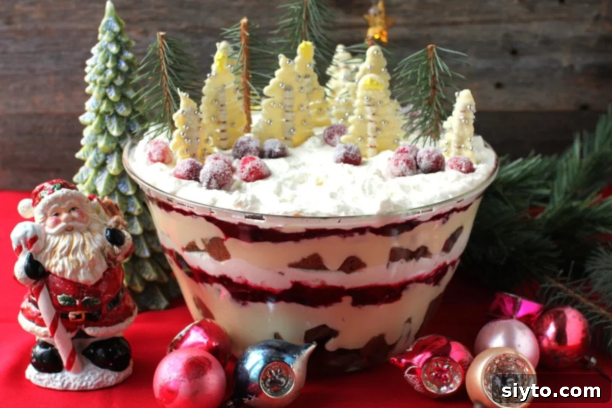 the big trifle bowl filled with layers of Lebkuchen Christmas trifle and topped with little white chocolate trees.
