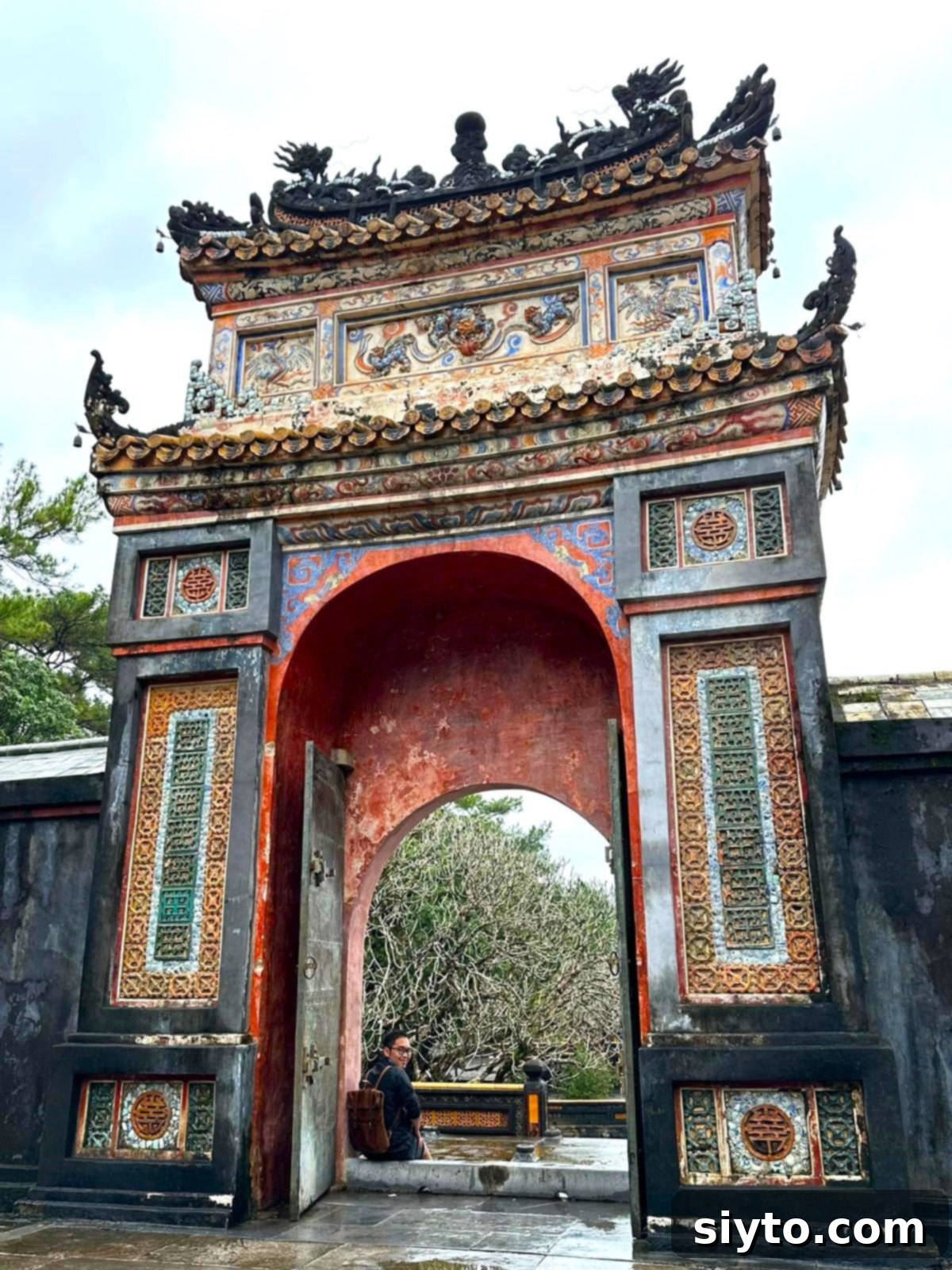 Jay sitting in the gate of a temple