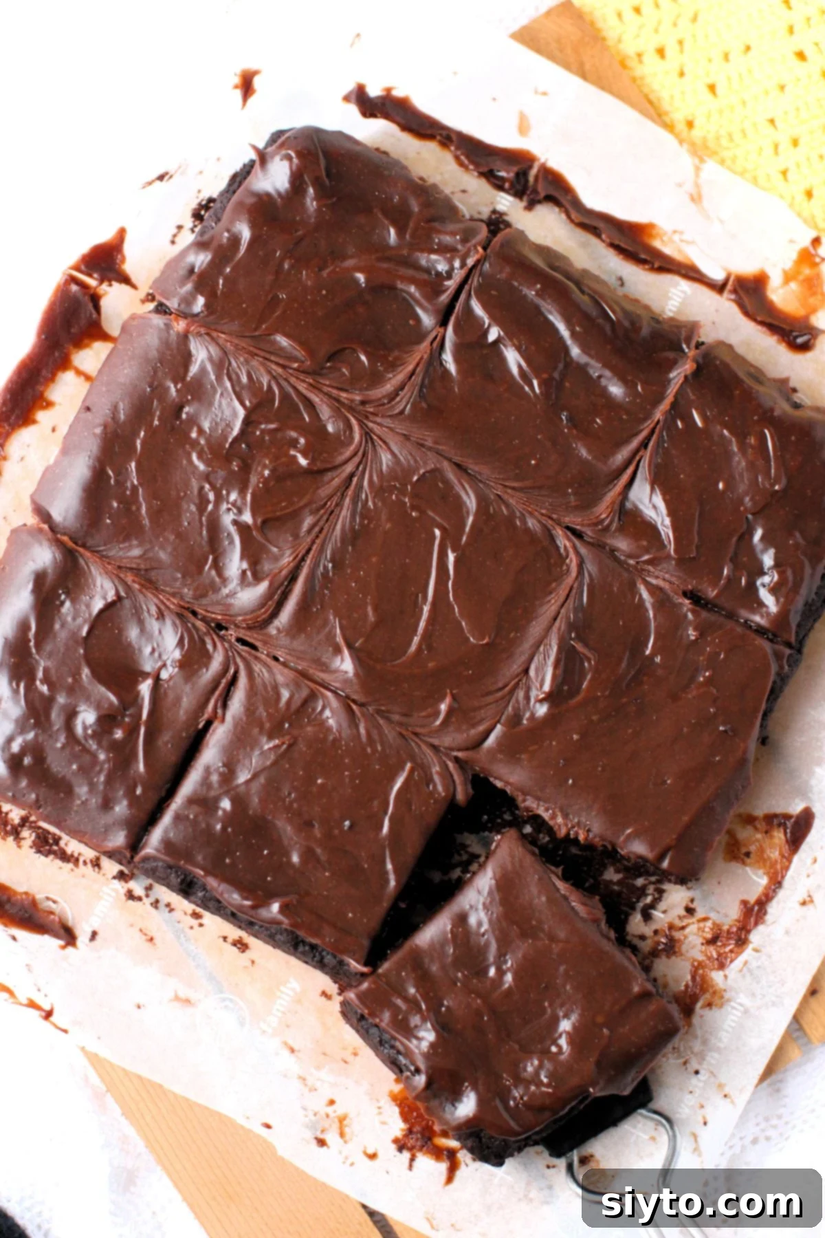 A top-down view of the red wine chocolate cake, perfectly cut into nine squares on a piece of parchment paper.