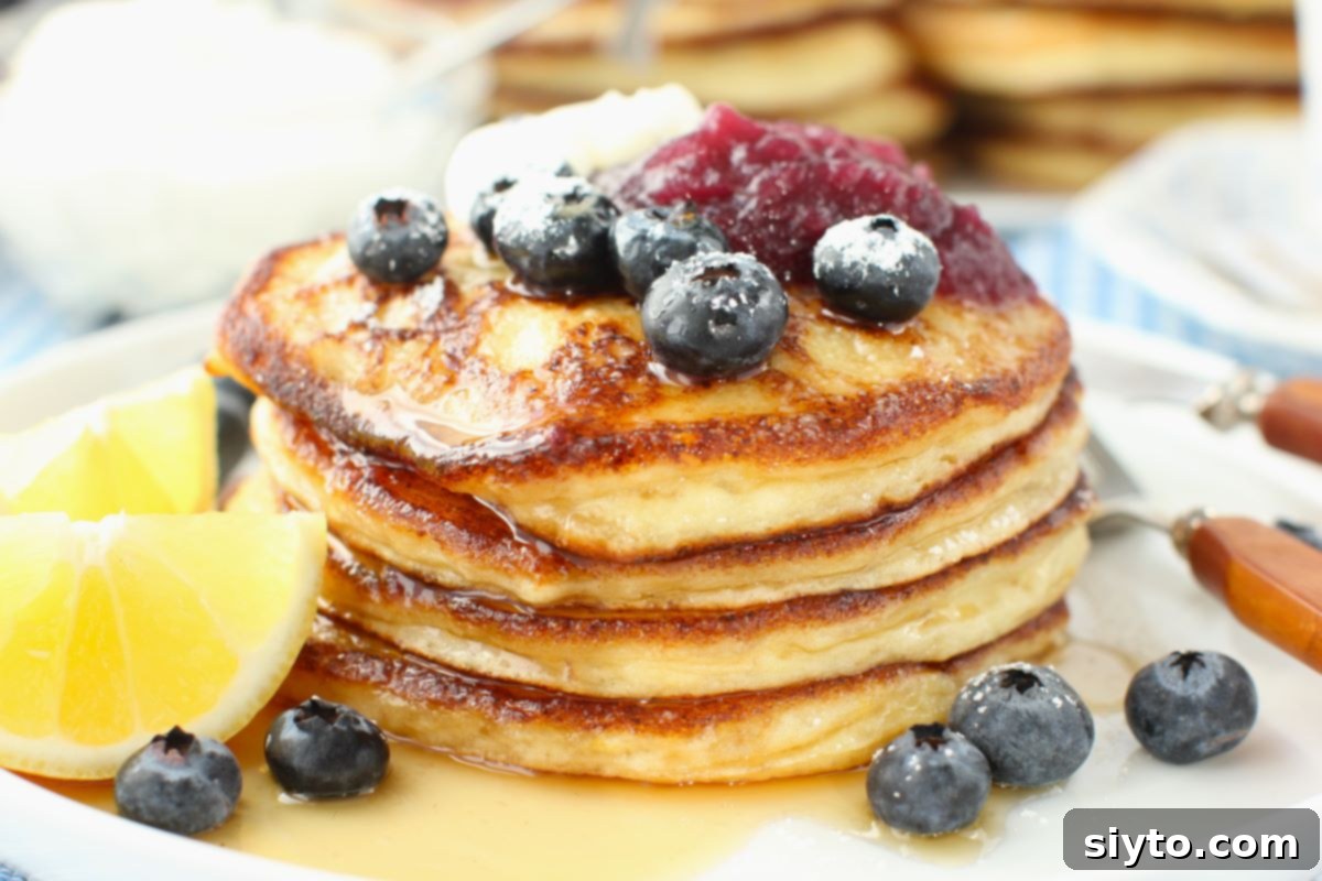 Fluffy Lemon Ricotta Pancakes 9 close-up view of stack of Lemon Ricotta Pancakes.
