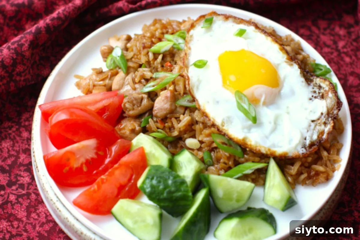 Indonesian Fried Rice Nasi Goreng 7 plate of nasi goreng with fried egg on top.