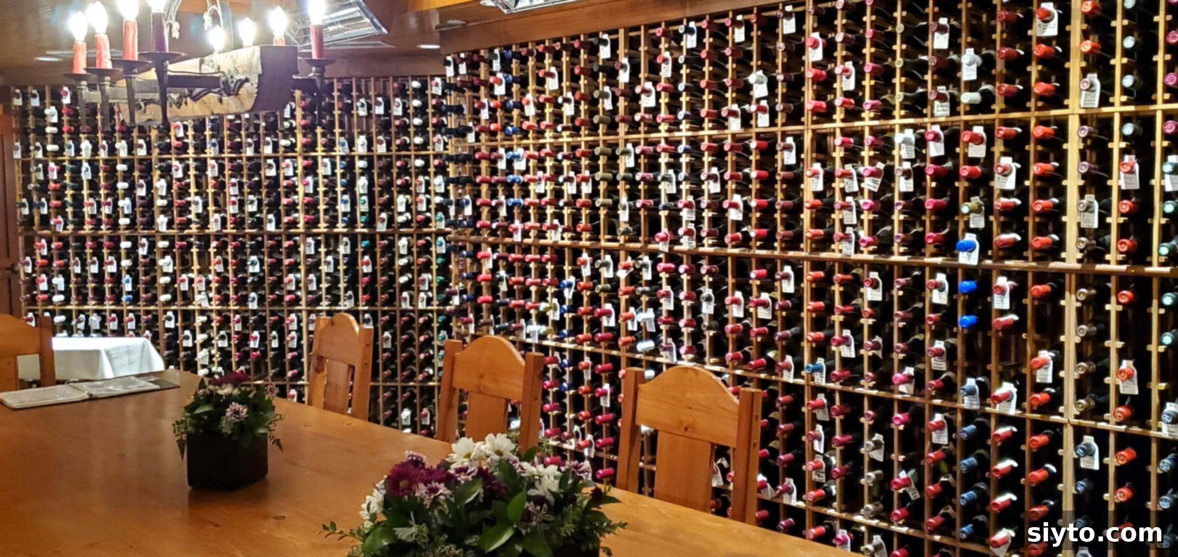 Sweet Bites Snowy Sleds: Lake Louise Adventures 10 A massive wall filled entirely with wine bottles, showcasing the extensive collection of the Post Hotel's wine cellar.