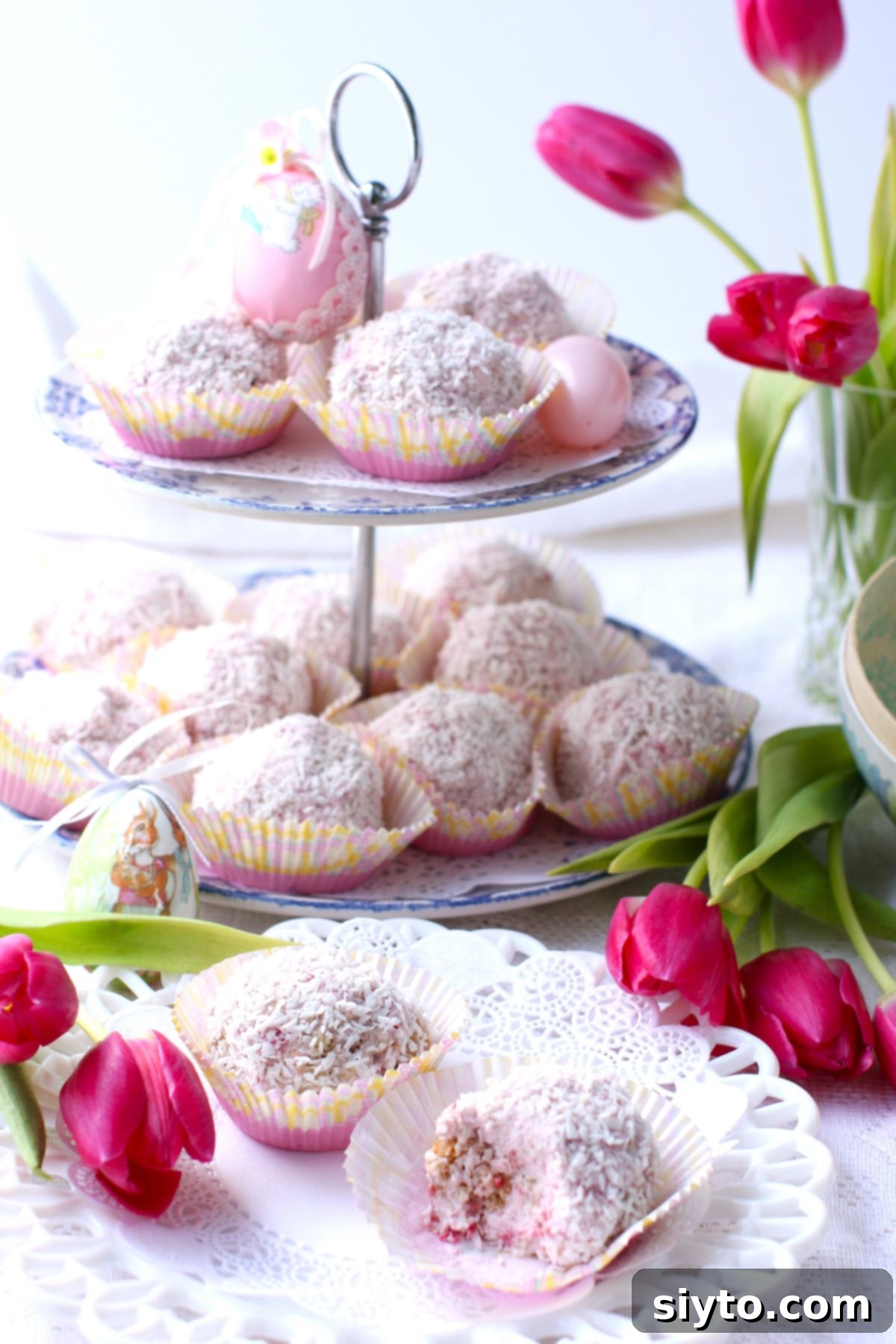 Raspberry Snowballs 2 2-tiered stand with Raspberry Schneeballen, two Schneeballen on plate, tulips in vase and on table.