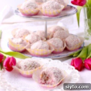 Raspberry Snowballs 14 square thumbprint photo of 2-tier tray with snowballs in paper muffin cups, plate in front with 2 snowballs on it.
