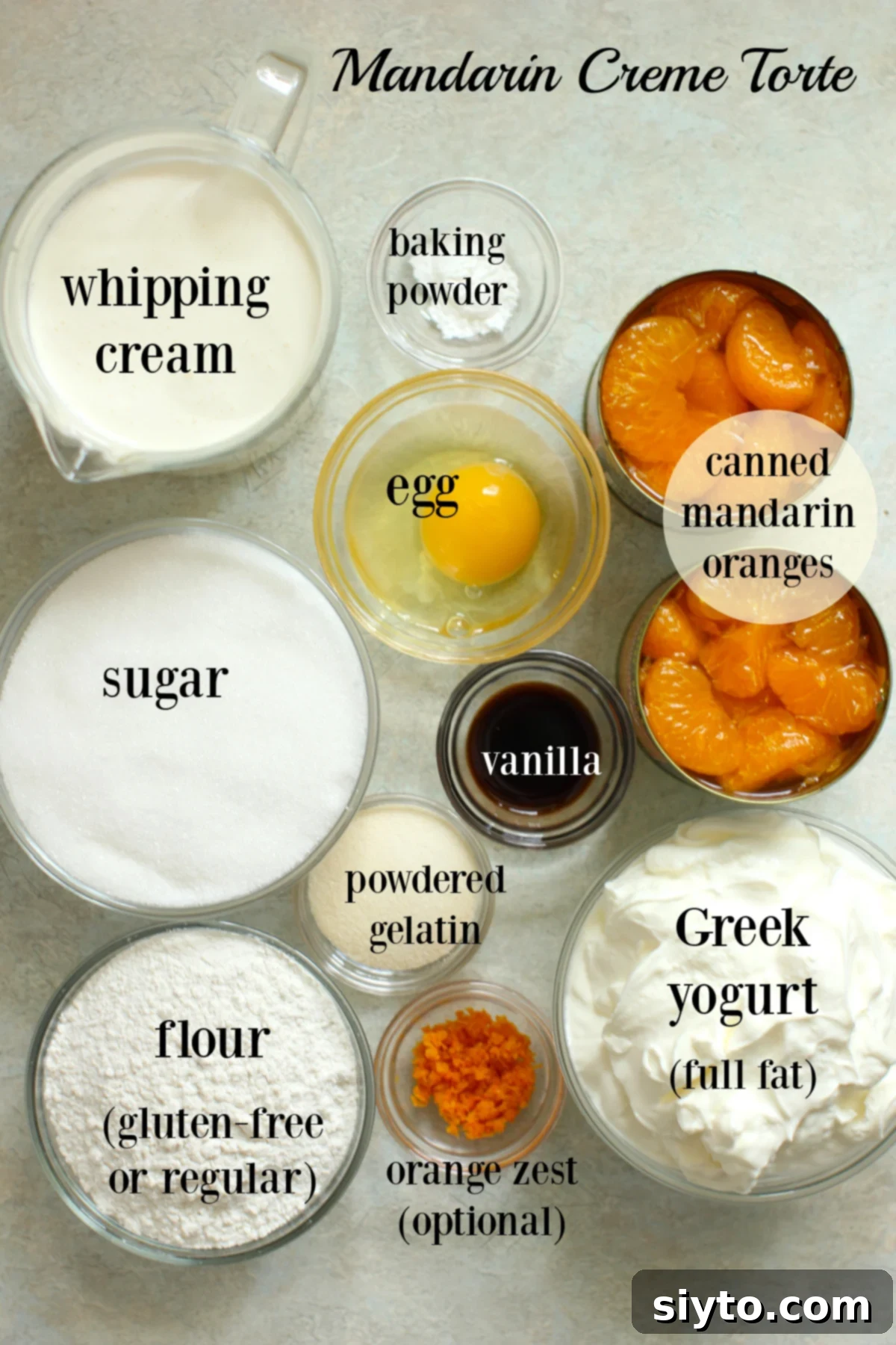 Luscious Mandarin Cream Torte 4 A meticulously arranged photo showcasing all the ingredients required for the German Mandarin Cream Torte. Each component, from the canned mandarin oranges to the Greek yogurt, flour, sugar, and gelatin, is neatly placed in small bowls and clearly labeled, simplifying the preparation process for home bakers.