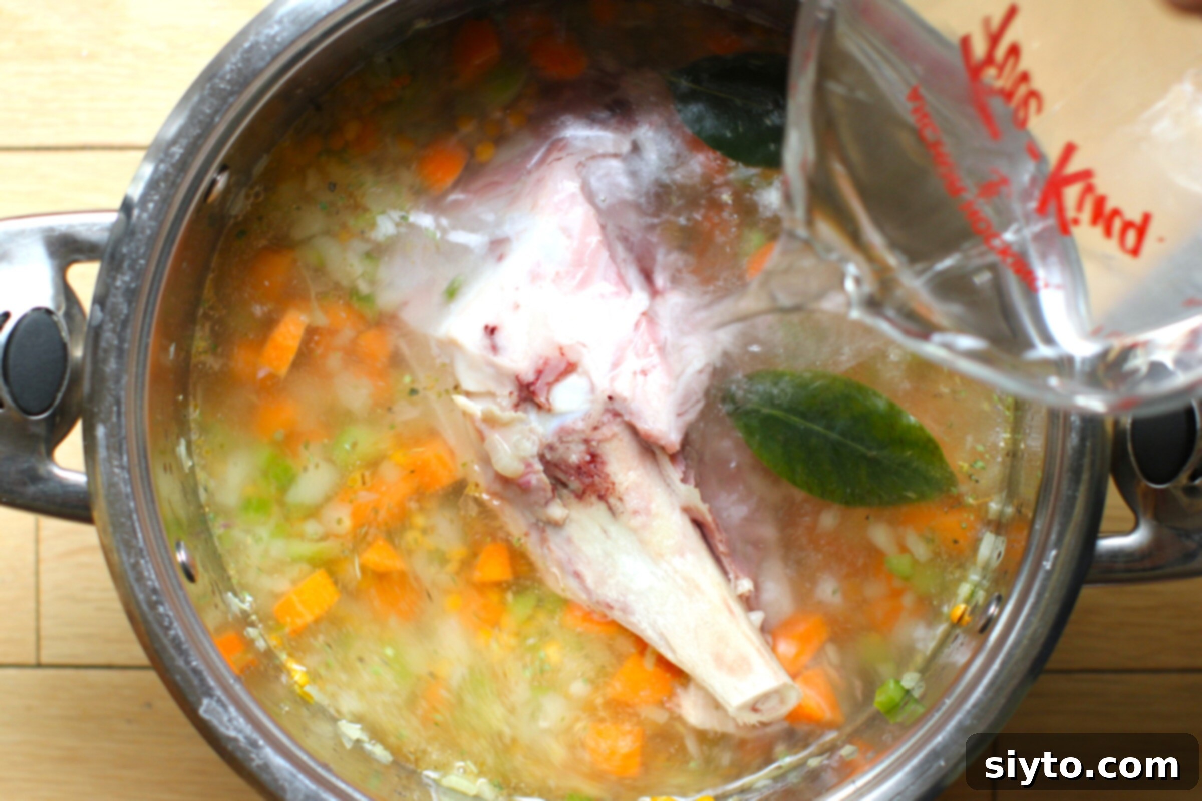Perfectly Simple Split Pea Soup 6 pouring water into the soup pot with the other ingredients.