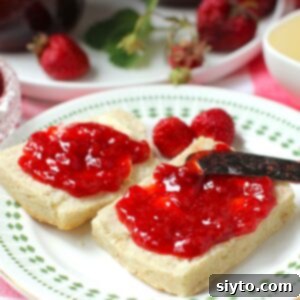 Reduced Sugar Strawberry Jam 10 Square thumbnail photo of low sugar strawberry jam spread on biscuit halves.