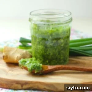 A close-up of the finished Ginger Scallion Sauce in a jar, showcasing its vibrant texture and inviting color.