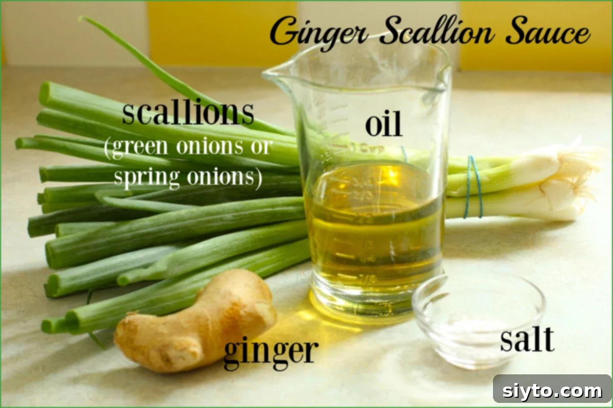 The four essential ingredients for making ginger scallion sauce laid out on a cutting board: fresh ginger, a bunch of scallions, fine sea salt, and a bottle of neutral oil.
