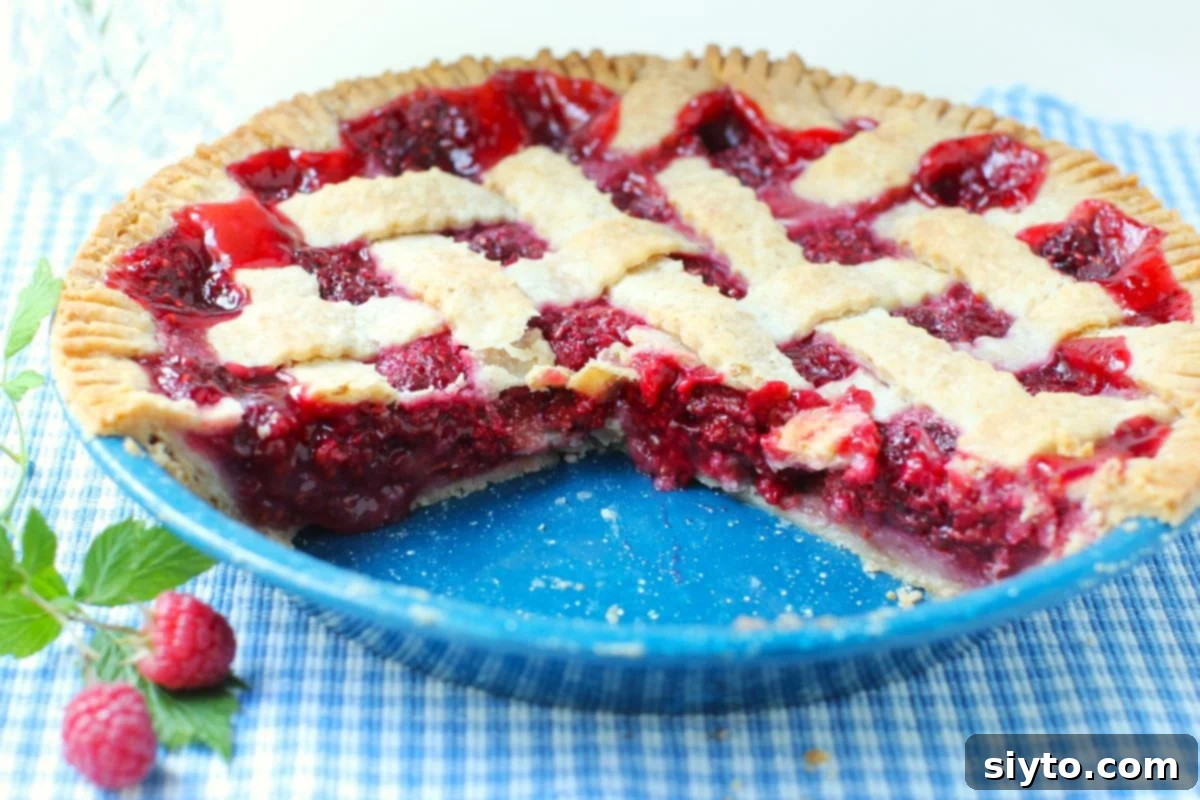 Raspberry Pie with a couple of pieces missing, showing the delicious filling.