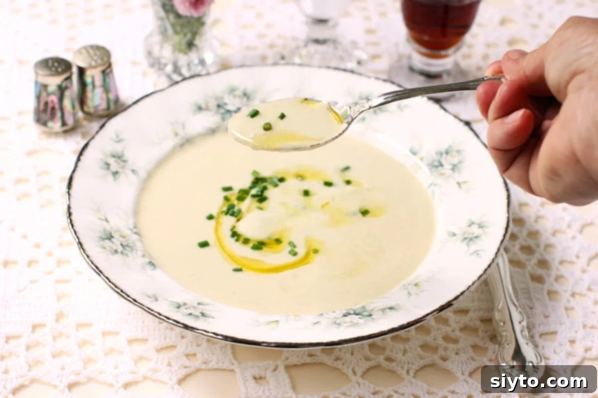 lifting a spoonful of creamy puffball soup from the bowl.