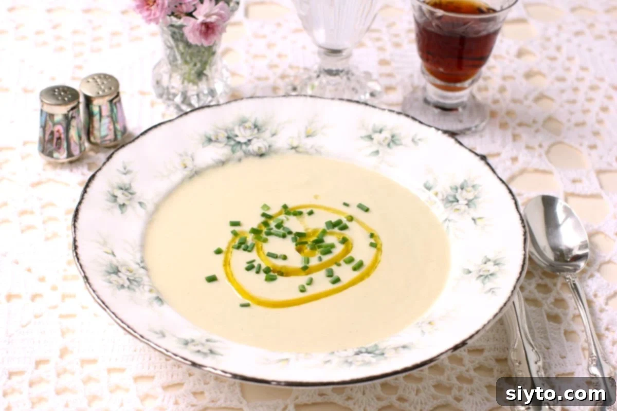 bowl of puffball soup with a drizzle of olive oil and chopped chives.