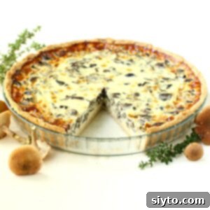 Foraged Fungi Quiche with a Gluten-Free Base 12 Wild Mushroom Quiche with a slice cut out of it.