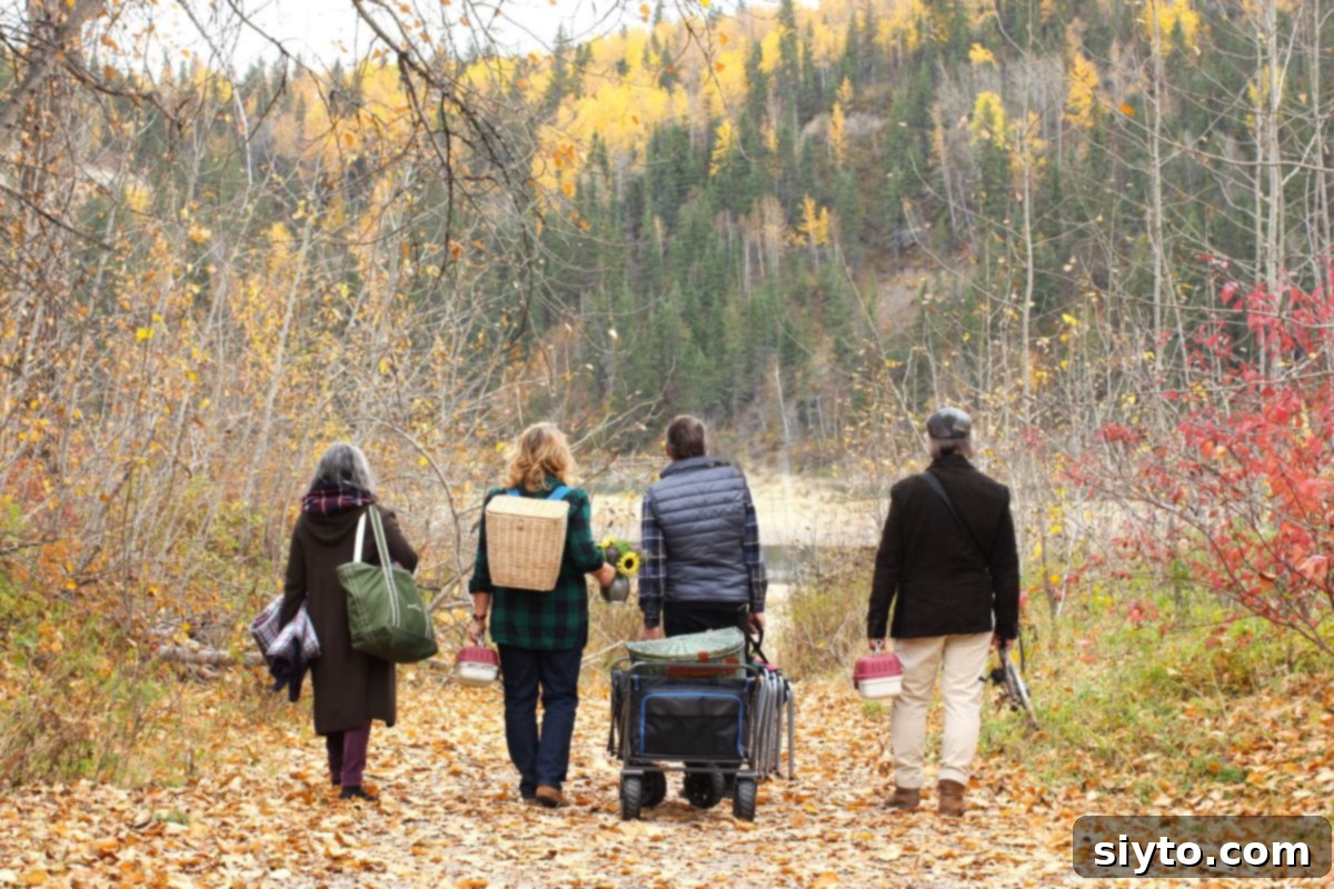 The four of us walking down to the river carrying our picnic gear and pulling the wagon.