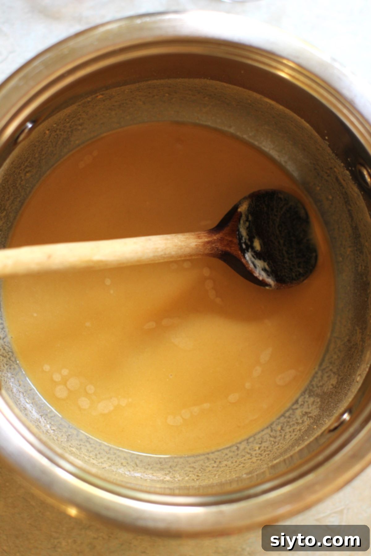 Apple Day From Press to Gravy Pot 9 Cooking the roux to a rich golden-brown colour in a saucepan with a wooden spoon.