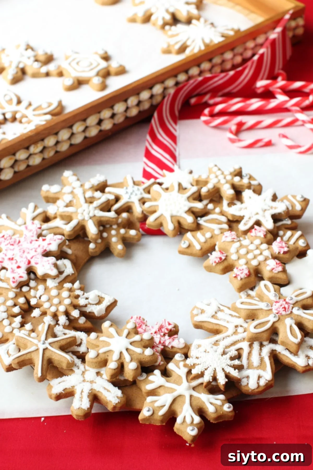 All the snowflake cookies are meticulously placed and secured on the gingerbread wreath, creating a layered and festive design.