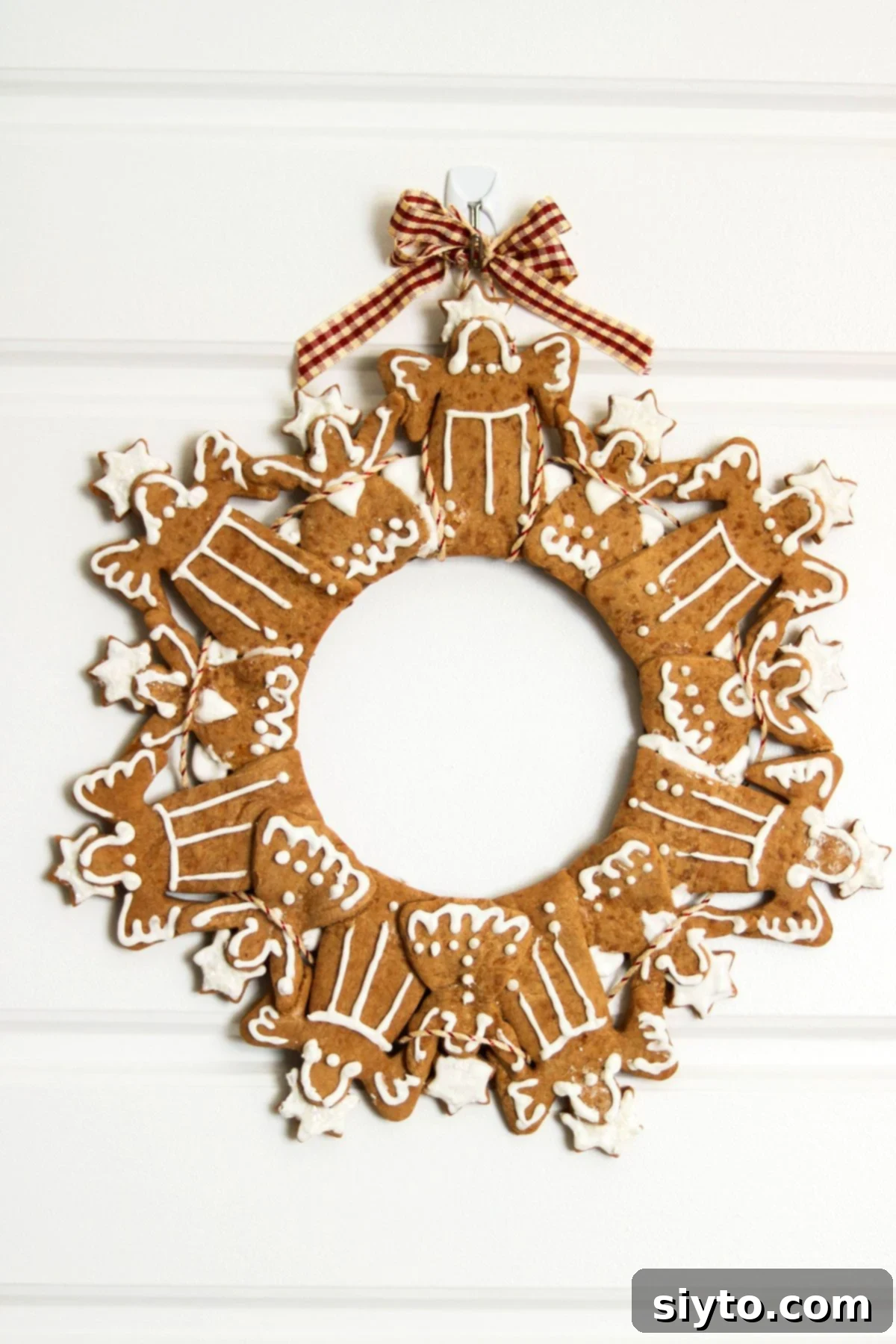 Nicoletta & Loreto's charming Angel cookie wreath hanging on a white door, showcasing a different themed design.