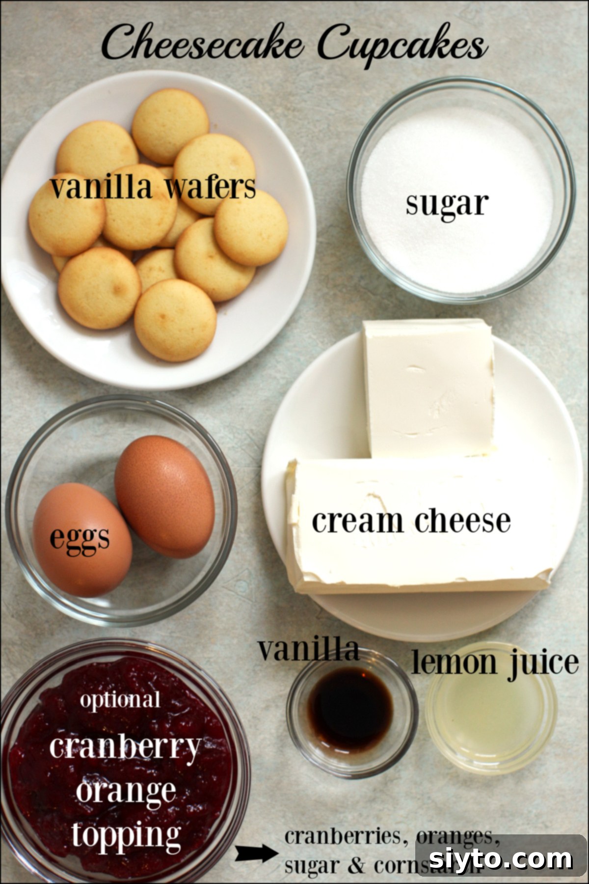 Labeled ingredients for making Cheesecake Cupcakes, including cream cheese, sugar, lemon juice, vanilla, eggs, and vanilla wafers.
