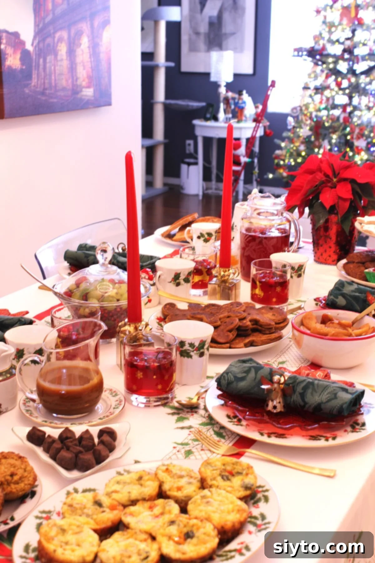 A beautifully set holiday brunch table, with savory baked egg bites in the foreground, gingerbread pancakes in the center, and an array of other delicious goodies arranged around them.
