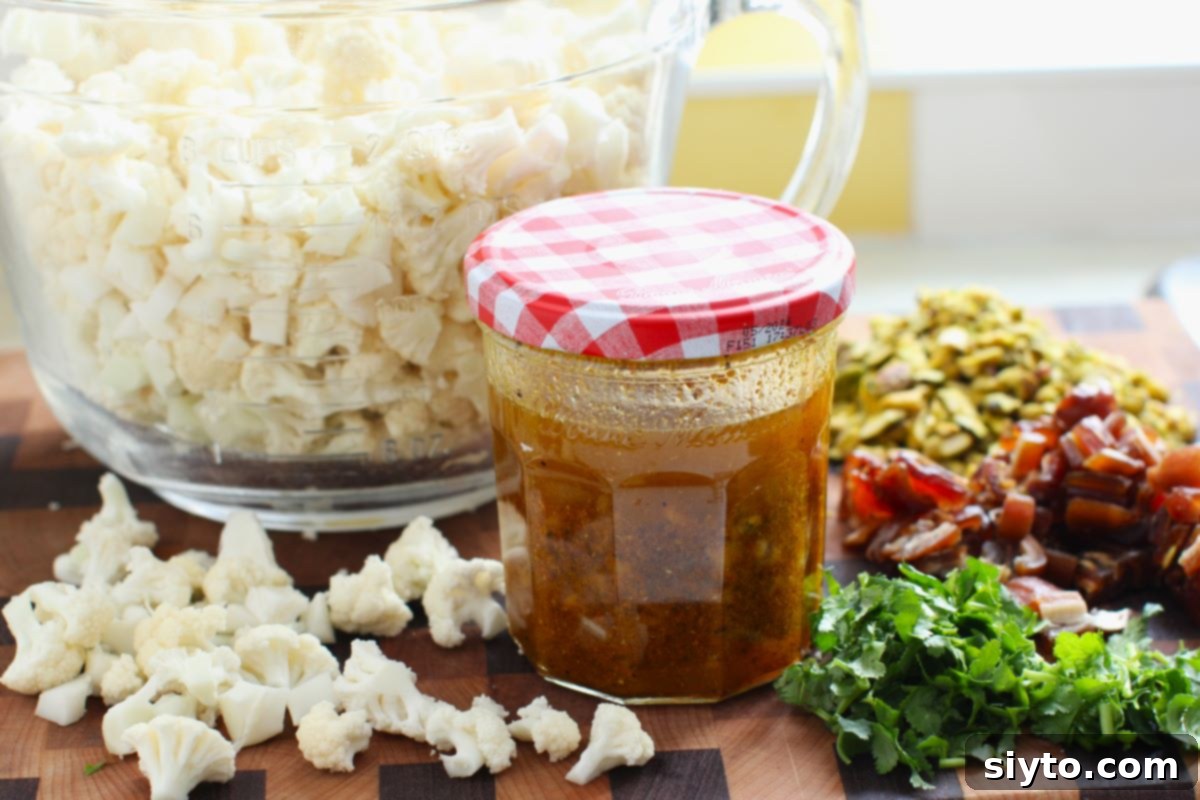 Jar of salad dressing, with salad ingredients behind it.
