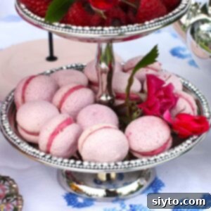 Square thumbnail of Raspberry Meringue Kisses on a silver tiered tray, with pink flowers.
