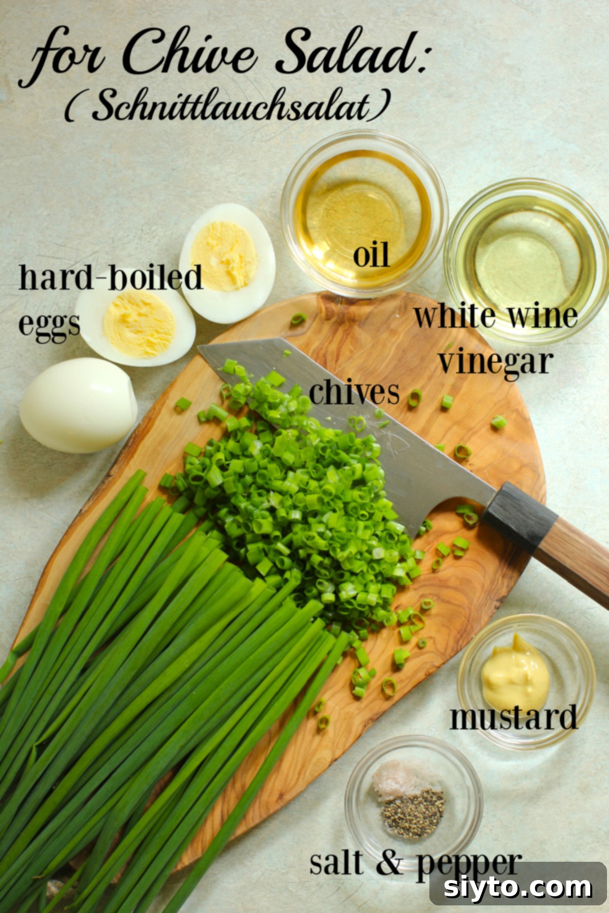 Labeled essential ingredients laid out for preparing a German Chive Salad (Schnittlauchsalat): fresh chives, hard-boiled eggs, neutral oil, white wine vinegar, and Dijon mustard.