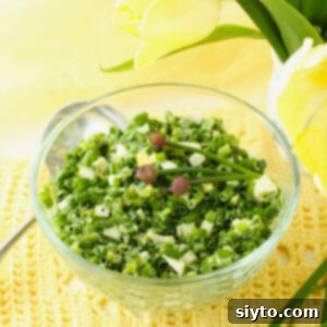 Square thumbnail photo of a clear glass bowl with vibrant German Chive Salad, set against a cheerful yellow background.