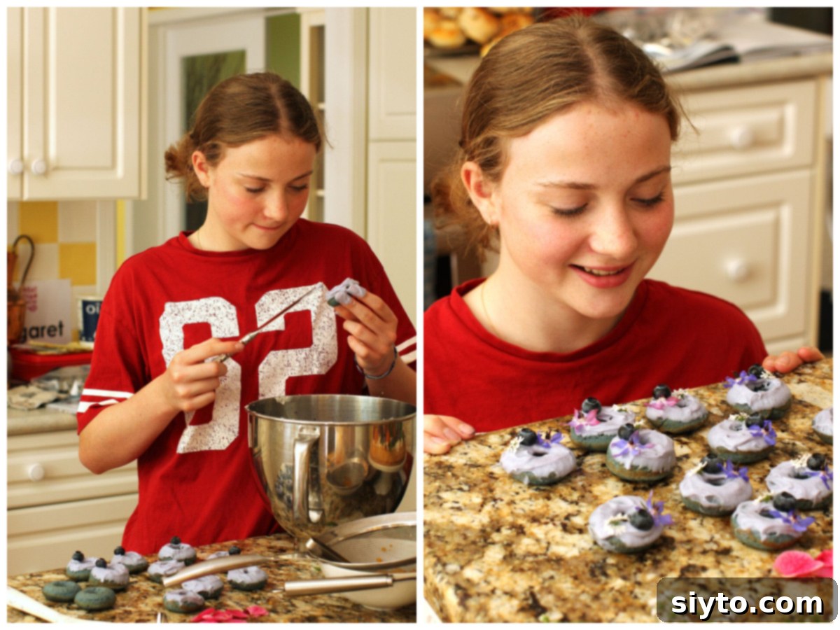 A two-photo collage showing the frosting process. The left image depicts Amelia spreading icing on a mini blue donut, while the right image shows her admiring the collection of beautifully decorated mini blue donuts.