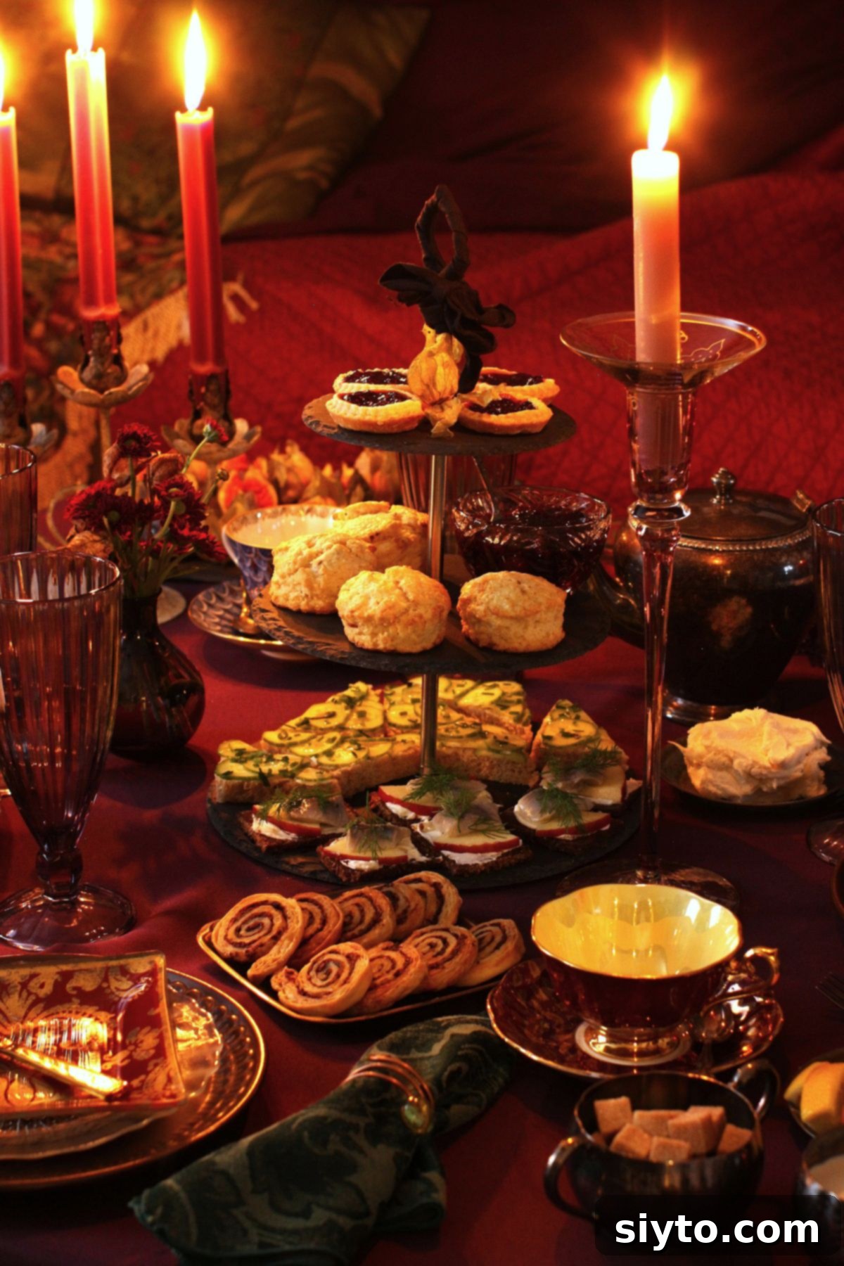 3-tiered cake stand filled with goodies for the moody magic afternoon tea, on the fully set tea table.