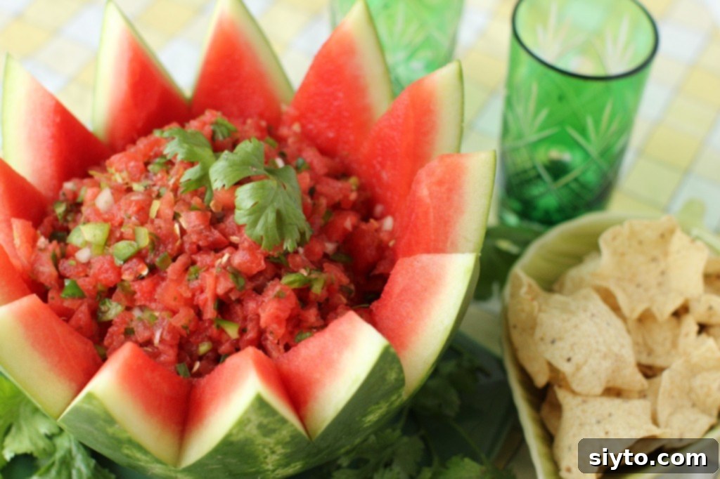 Vibrant sweet and spicy watermelon salsa served in a carved watermelon bowl with tortilla chips
