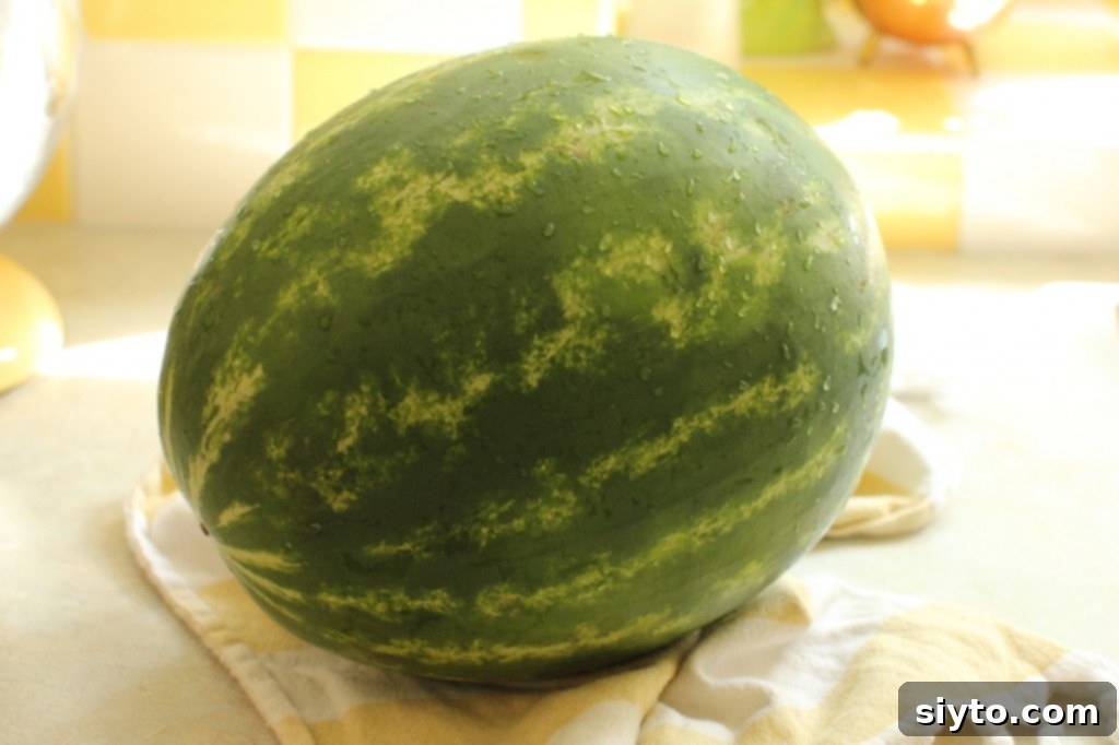 Half a fresh watermelon on a cutting board, ready to be prepared for the salsa recipe