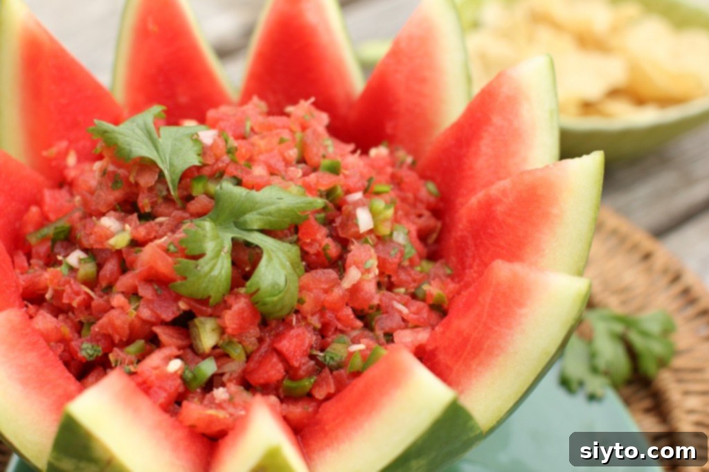 Fresh ingredients for watermelon salsa laid out on a table, including chopped watermelon, cilantro, peppers, and lime