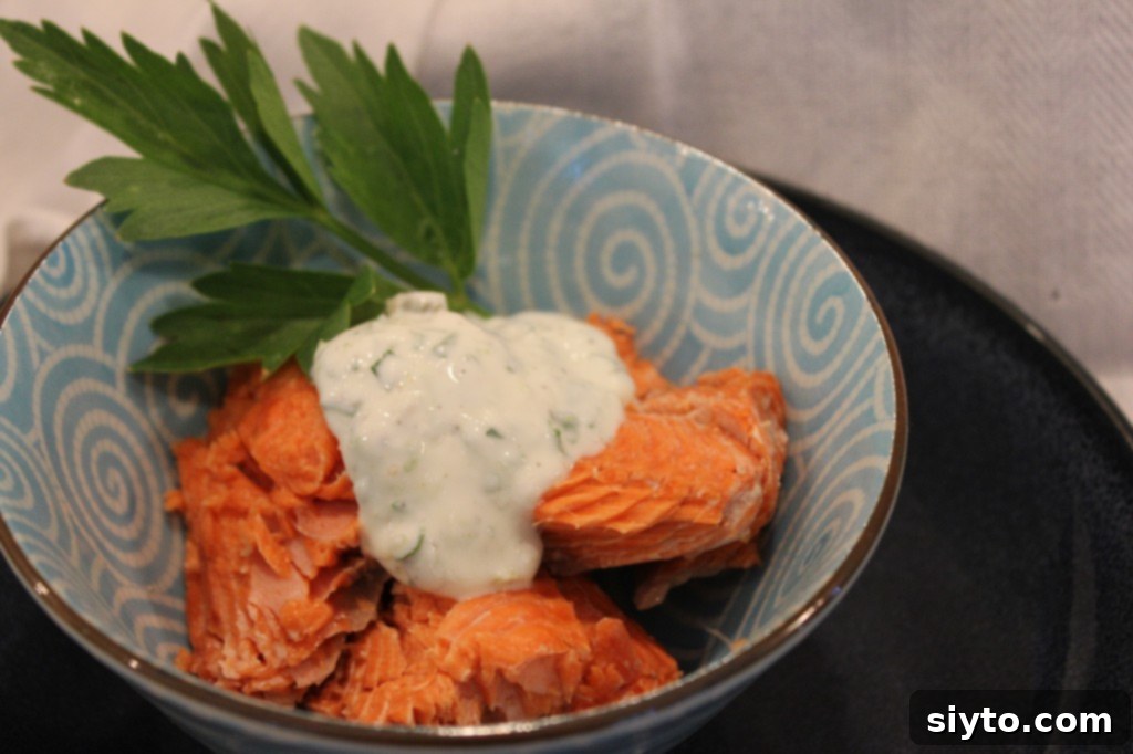 Foil-baked whole salmon infused with lime and fresh lovage, served alongside a vibrant herb tartar sauce.